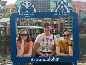 Ray, Sydney, and me standing in a Swan and Dolphin themed frame with the hotels behind us.